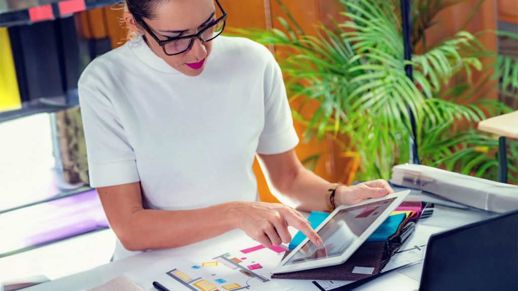 A person looking at fabric samples on an iPad.