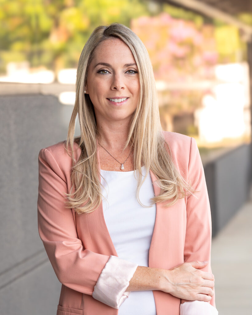 Beth Lalonde smiling in a blush blazer and pearl necklace, real estate agent at the Woodruff Road office